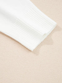 Detail of sleeve cuff of MERRY Letter Pattern Christmas Raglan Sleeve Sweater in white color.