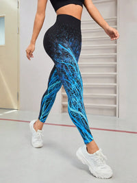 Model wearing seamless blue tree pattern high waist active leggings with white sneakers in a gym setting.
