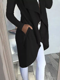 Full size lapel collar long sleeve coat in black with pockets, worn over white pants, showcasing stylish outfit.
