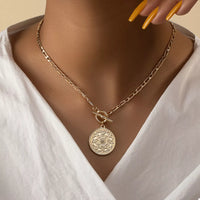 Chain Link Necklace with Vintage Coin Pendant worn by a model, featuring 18K gold-plated material.