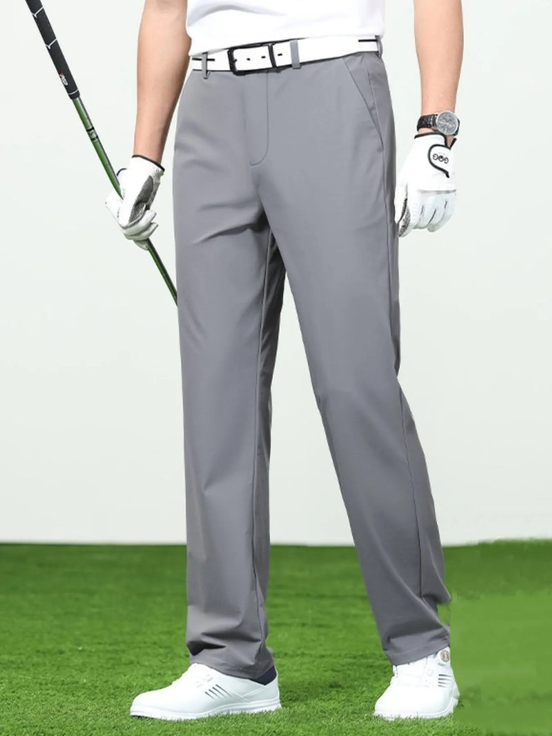 Men's loose fit pants in gray, featuring breathable material, styled for golf, with a classic belt and shoes.