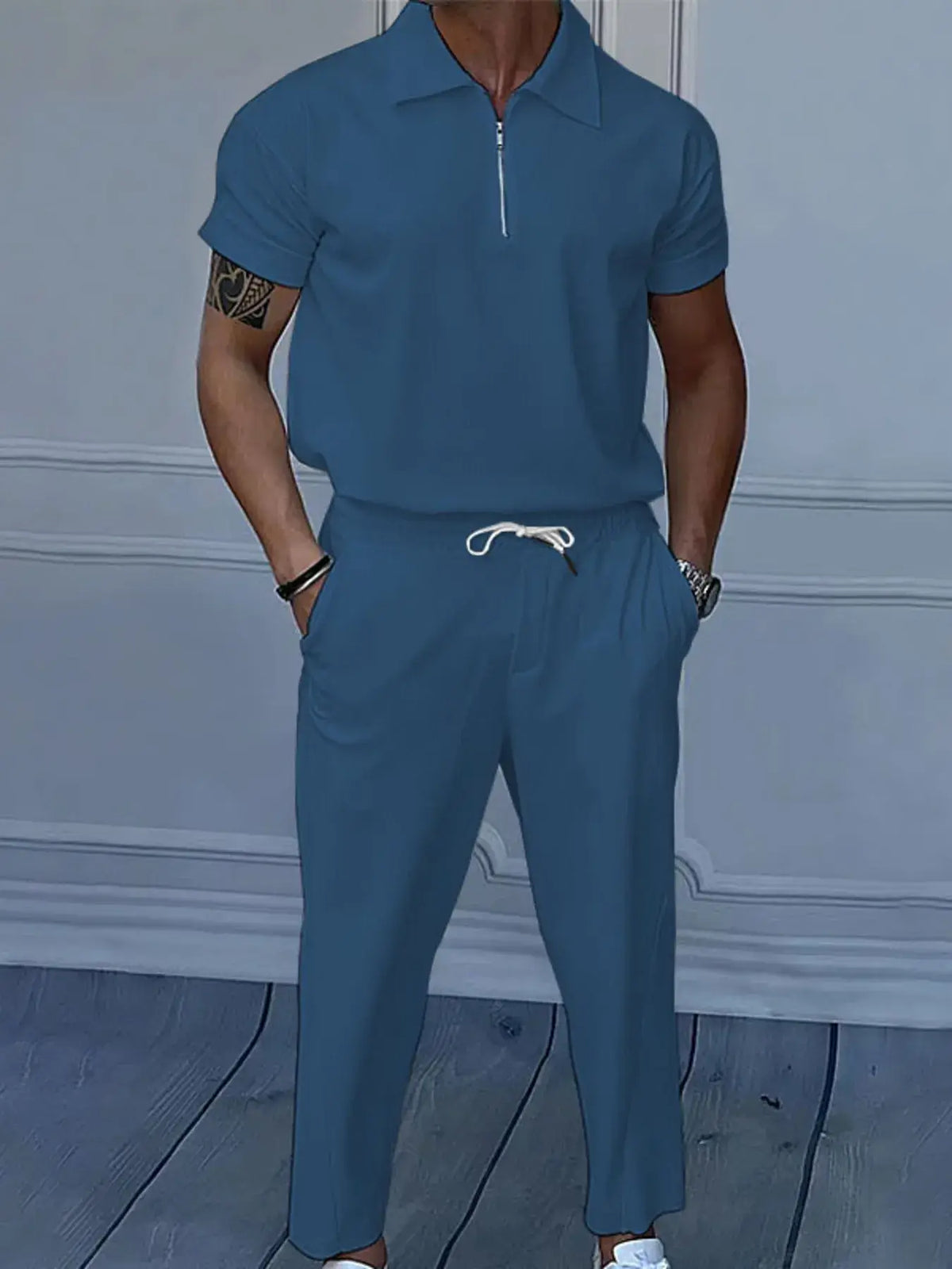 Men's full size quarter zip short sleeve polo and pants set in blue, featuring drawstring and pocket for comfort.