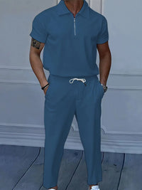 Men's full size quarter zip short sleeve polo and pants set in blue, featuring drawstring and pocket for comfort.