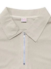 Close-up of men's quarter zip polo collar in beige, featuring a sleek design and textured fabric.