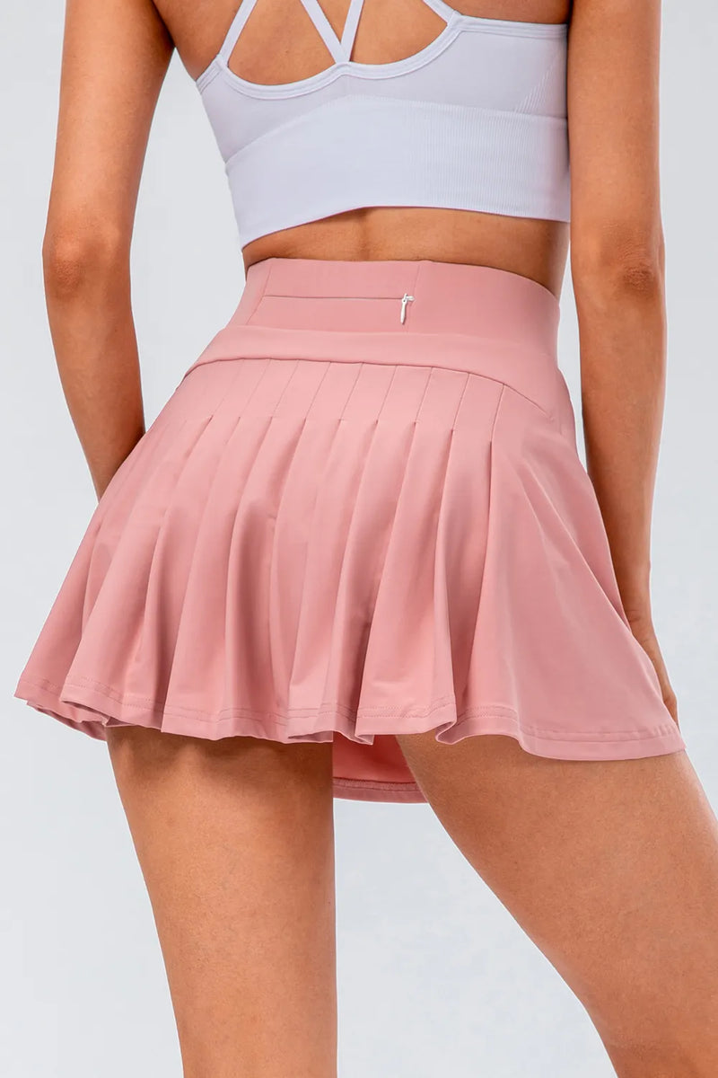 High waist pleated active skirt in pink, featuring a stretchy fit and flattering silhouette for active wear.