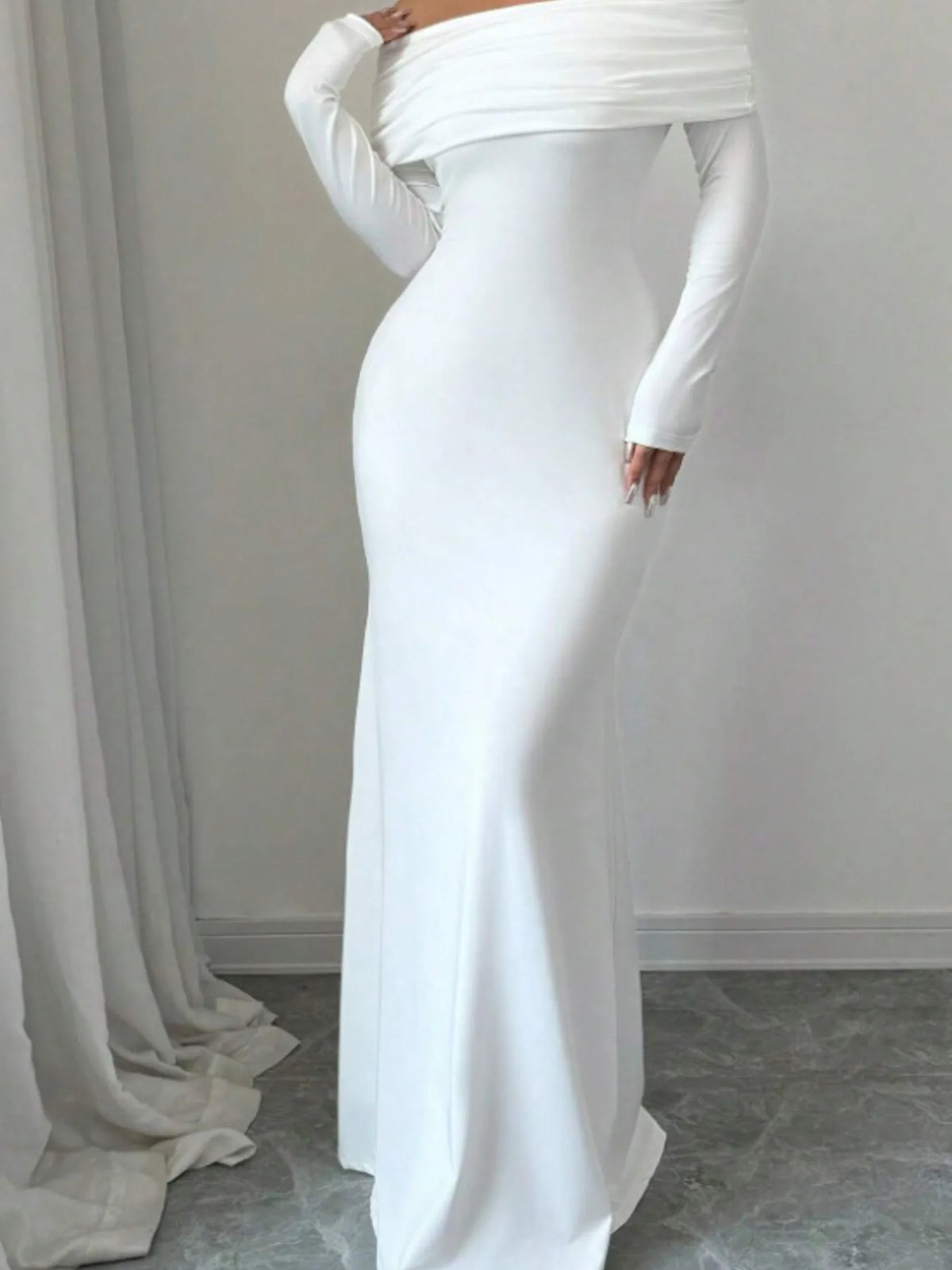 Off-shoulder long sleeve bodycon maxi dress in white, ideal for luxurious weddings, showcasing a sleek silhouette.