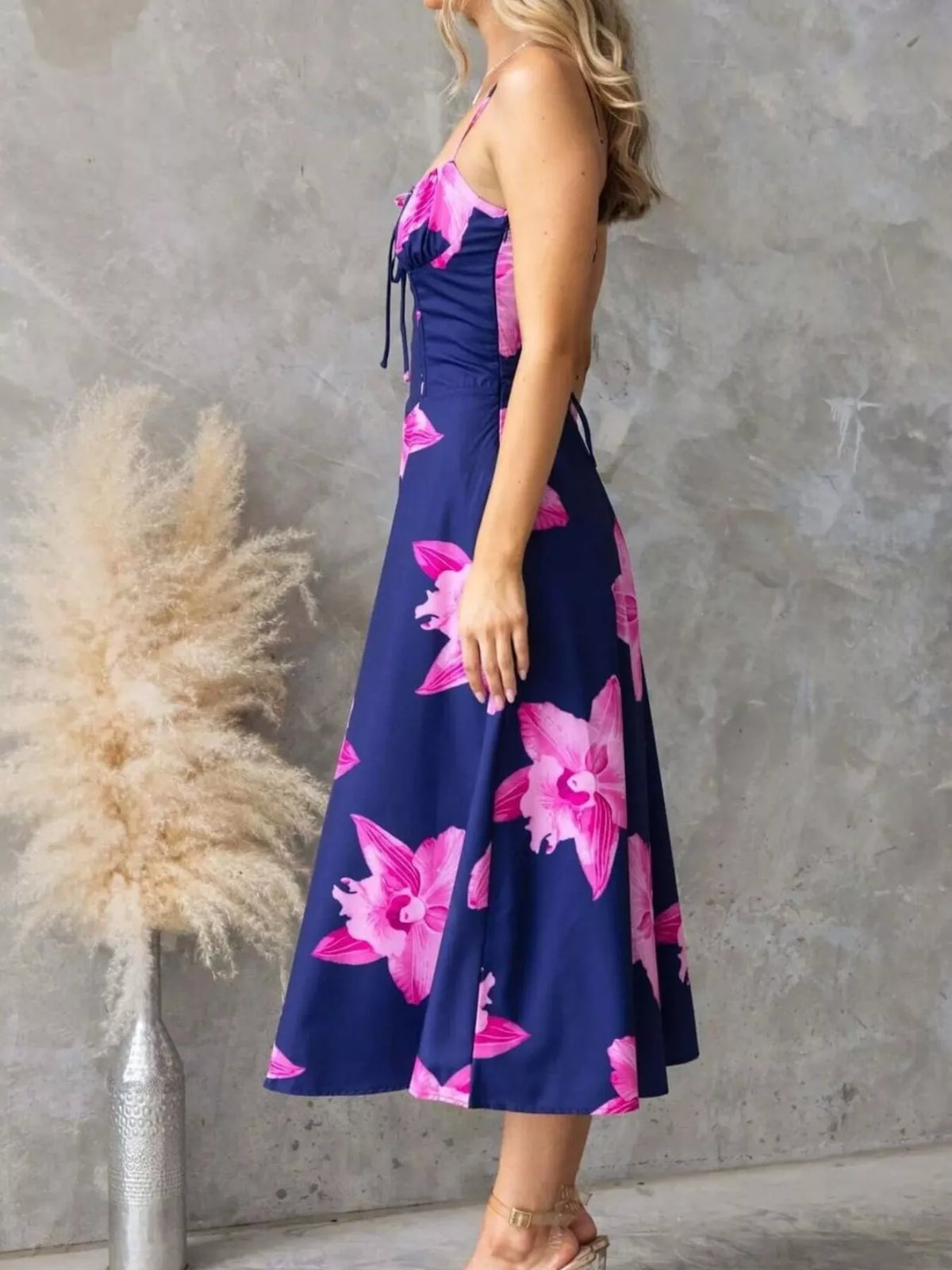 Floral Print Midi Cami Dress styled with pink flowers against a navy background, featuring a tied lace-up design.