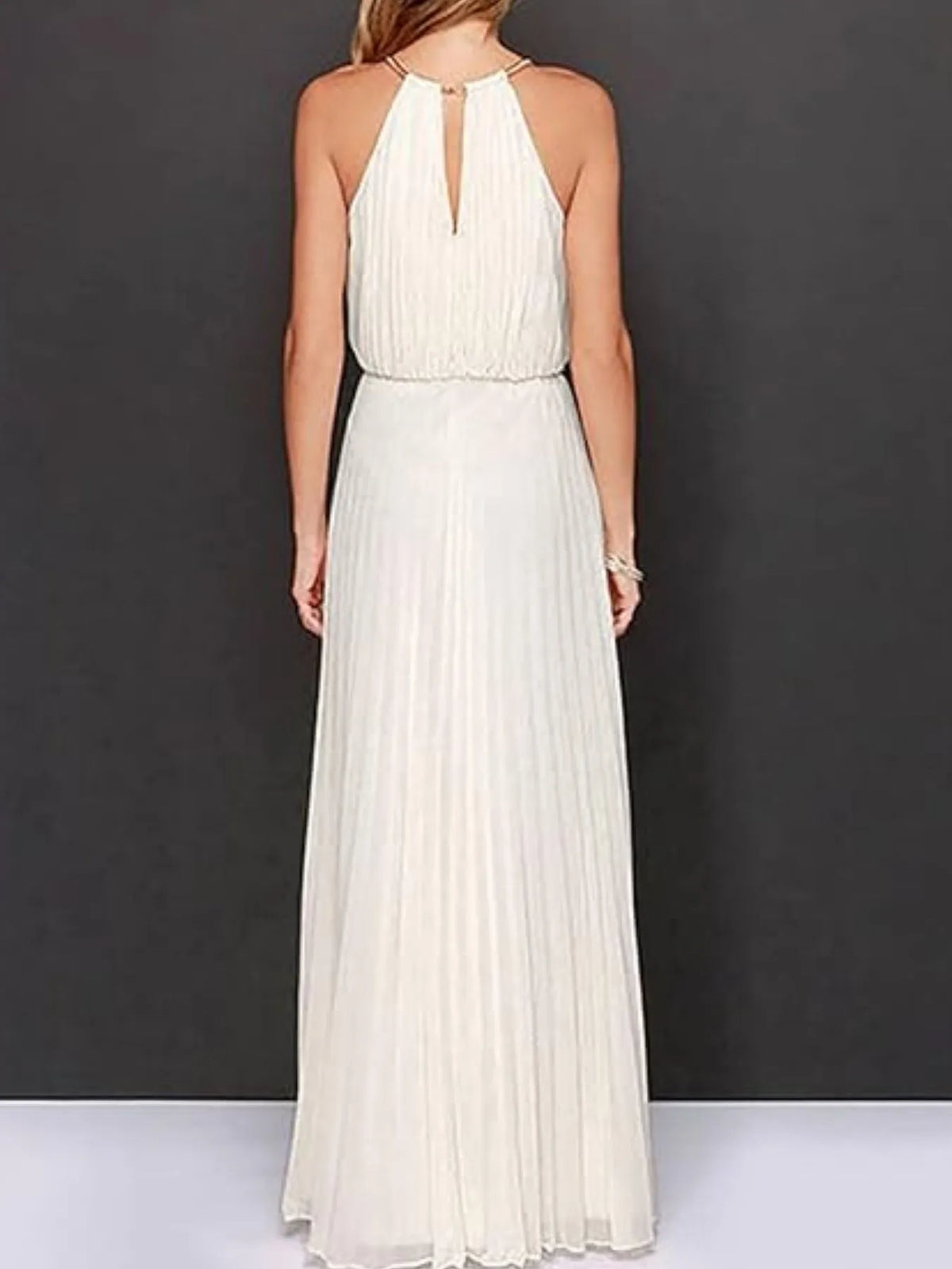 Back view of a pleated sleeveless maxi tank dress in cream, showcasing elegant lines and a keyhole neckline.