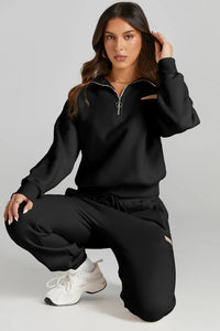 Stylish woman in black quarter zip top and drawstring pants active set, showcasing affordable activewear.
