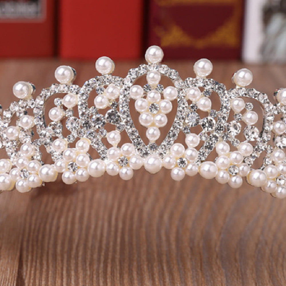 a tiara with pearls on a wooden table