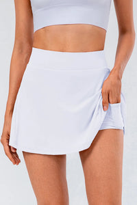 High waist pleated active skirt in light color, featuring stretchy fabric with side pocket for versatility.