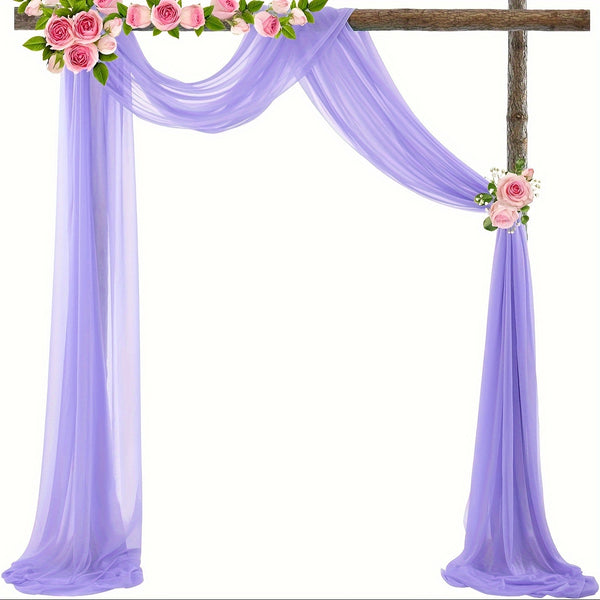 a cross decorated with pink roses and greenery