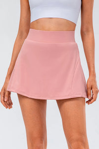 High waist pleated active skirt in soft pink, featuring a stretchy fabric and a flattering silhouette for active wear.