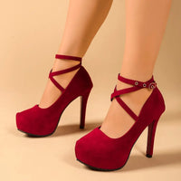 Red ankle strap high heel pumps made of suede, ideal for luxurious weddings and formal wear.