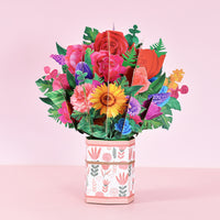 a vase filled with lots of colorful flowers