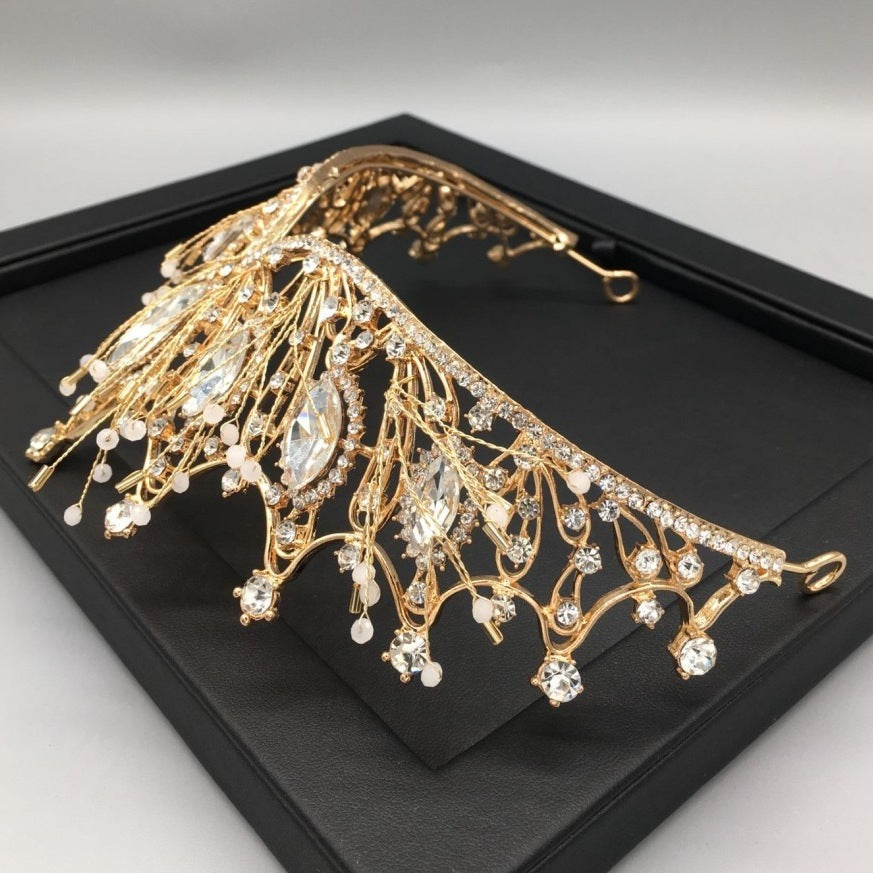 a gold tiara on a black tray