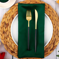 a place setting with a green napkin, fork and knife