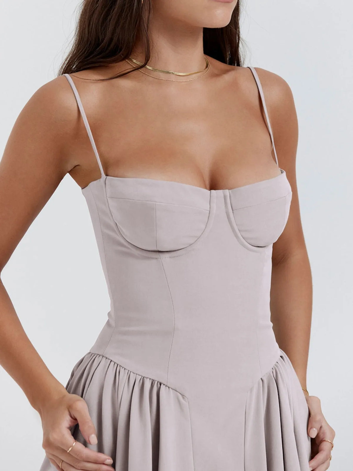 Ruched sweetheart neck cami dress in light beige with spaghetti straps and fitted bodice, showcasing stylish feminine details.
