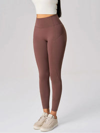 High waist active leggings in brown with side pockets, breathable stretch fabric, perfect for workouts and casual wear.