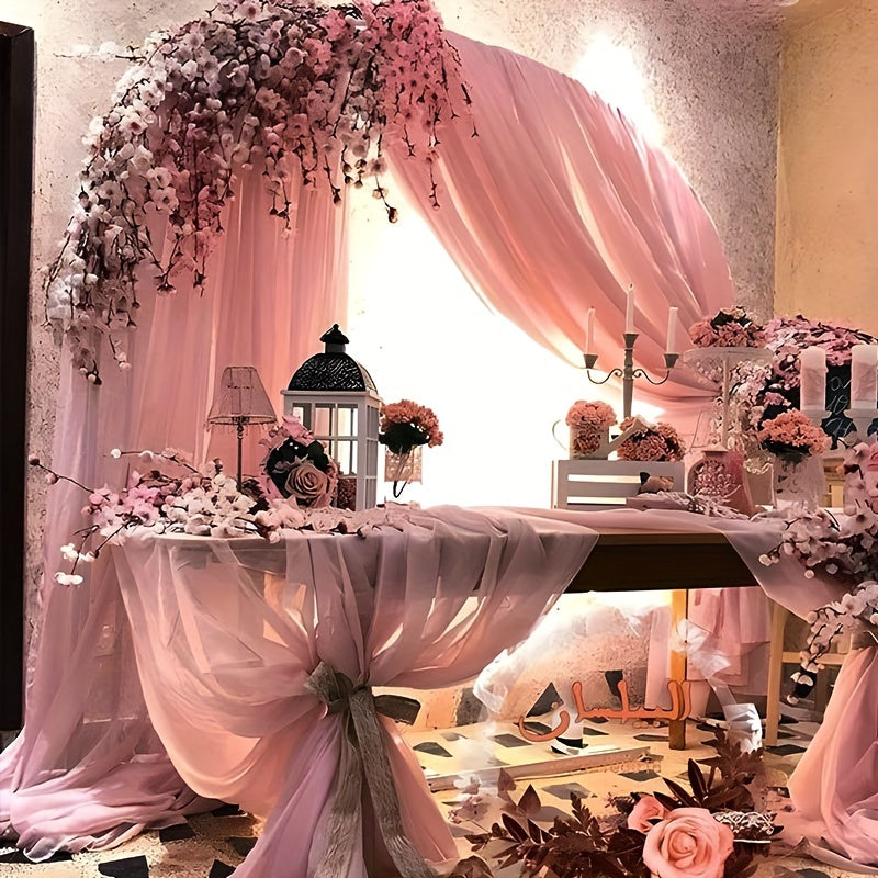 a table with a pink table cloth and flowers on it