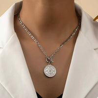 Chain Link Necklace with Vintage Coin Pendant displayed on a model's neck, showcasing its elegant design.