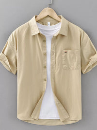 Men's plus size plaid button-up short sleeve shirt in beige, featuring a pocket and casual style.