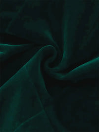 Luxurious green velvet fabric, showing a smooth and rich texture ideal for bridal and formal wear.