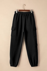 Black pocketed elastic waist joggers hanging on a hanger against a neutral background, ideal for affordable activewear.