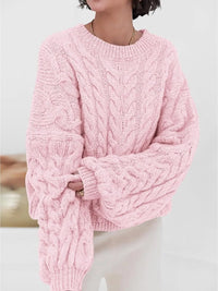 Cozy pink cable knit long sleeve sweater featuring wide sleeves and textured design, ideal for casual style.