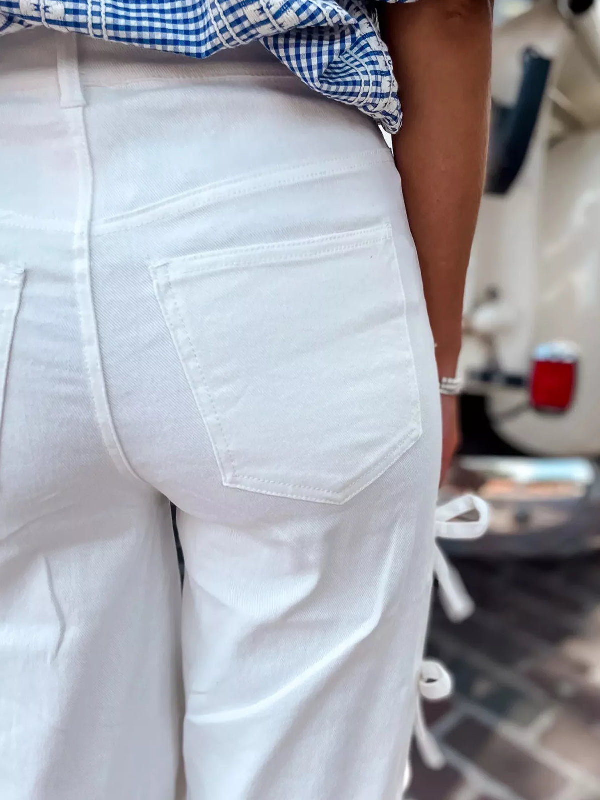 Close-up view of the back pocket of Bow-Accented Wide-Leg Pants in white, showcasing fine details and stylish design.