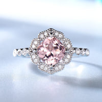 a ring with a pink diamond surrounded by white diamonds