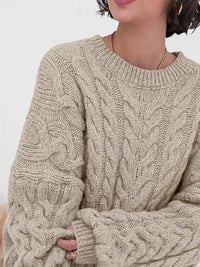 Cable knit long sleeve sweater in beige, featuring a textured design and relaxed fit, perfect for casual wear.