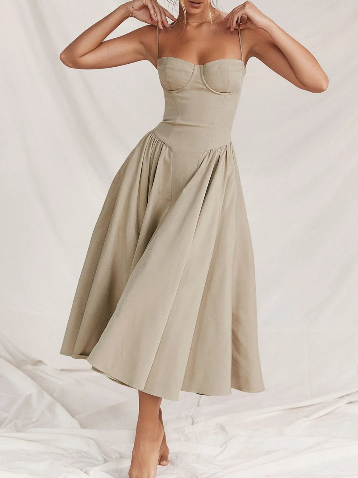 Ruched sweetheart neck cami dress in beige, featuring a flowy skirt and adjustable straps.