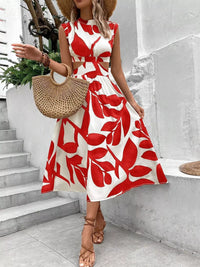 Cutout printed sleeveless dress featuring red leaf patterns, styled with a straw bag and heels, ideal for summer outings.