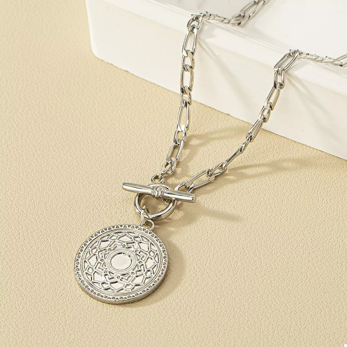 Chain Link Necklace with Vintage Coin Pendant displayed on a neutral background, showcasing its detailed pendant and chain design.