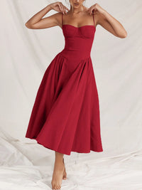 Ruched sweetheart neck cami dress in red, featuring a flowy skirt and adjustable straps, suitable for casual occasions.