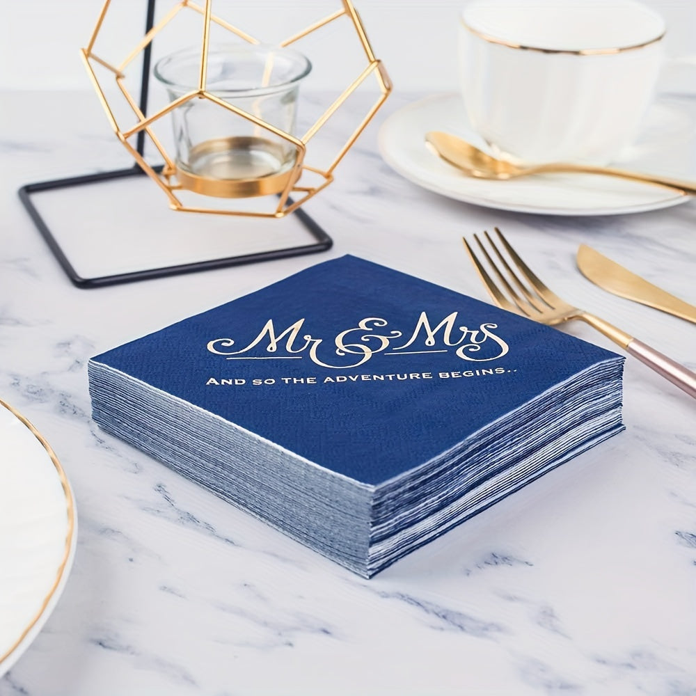 a stack of blue and gold wedding napkins on a table