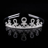 a tiara on a black background with a reflection