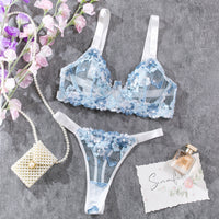 a blue and white bra and a necklace and flowers