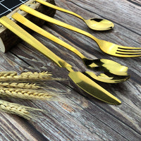 a wooden table topped with yellow forks and spoons