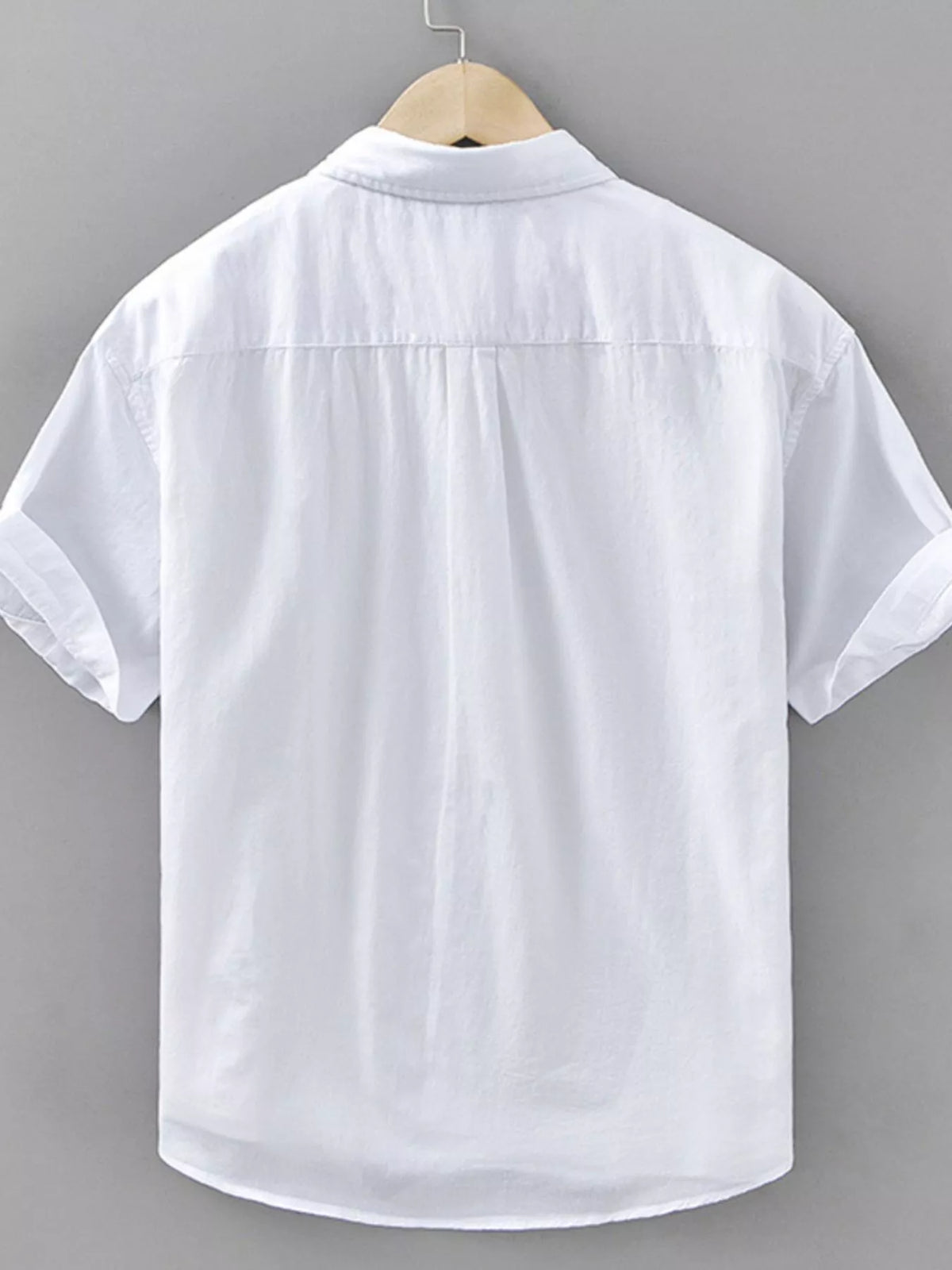 Back view of a men's plus size short sleeve white button-up shirt, featuring rolled sleeves and a classic collar.