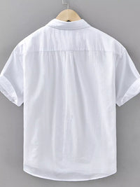 Back view of a men's plus size short sleeve white button-up shirt, featuring rolled sleeves and a classic collar.