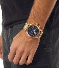 Nixon 51-30 Chrono Blue Dial Men's Watch A083-2735 worn on wrist with gold case and royal blue dial.