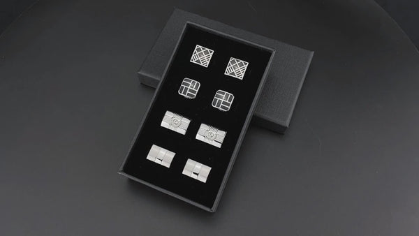 a set of four square and square cufflinks in a black box