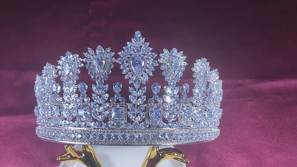 a tiara on a stand on a pink background
