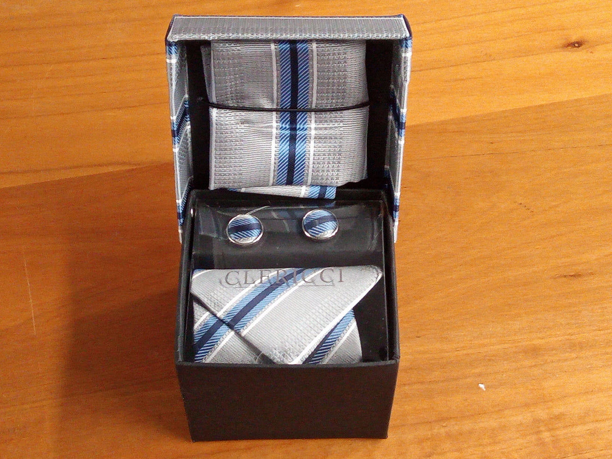 a tie and cufflinks in a box on a table