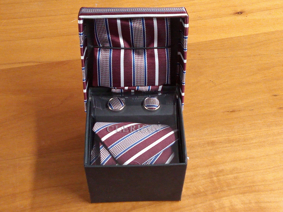 a tie and cufflinks in a box on a table