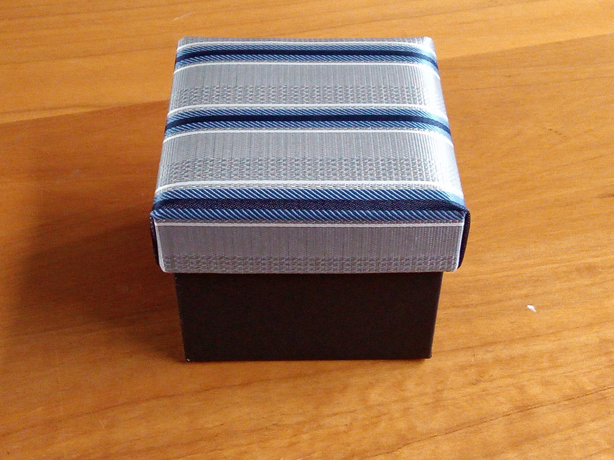 a small blue and white box sitting on a wooden table