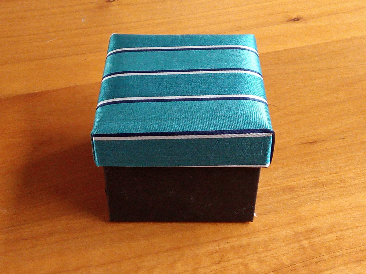 a small box with a blue and white stripe on it