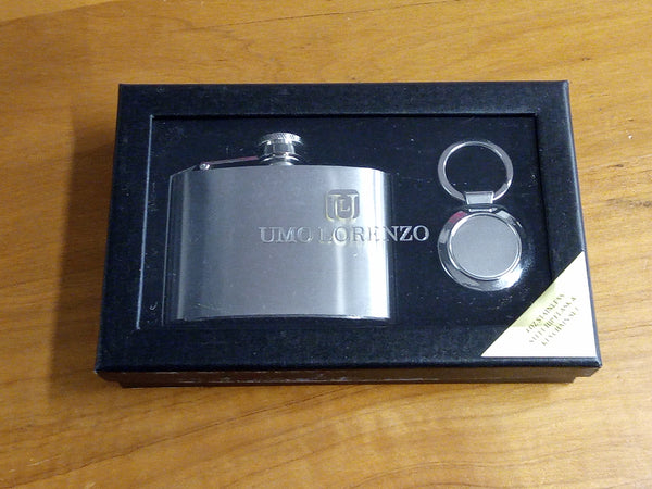 a flask and keychain in a box on a table